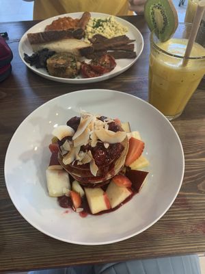 Buckwheat pancakes berry compote and fresh fruit and a vegan full English  at Eqvilibrivm Cafe in Barcelona