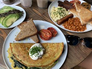 Chickpea omelette, full English breakfast, sliced avocado and shakes. at Eqvilibrivm Cafe in Barcelona