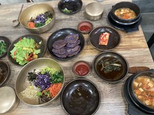 Bibimbap, tofu stew, red cabbage jeon? We just asked for bibimbap and got all of this haha  at Babiboyak in Jeju