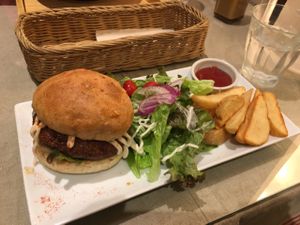 Tofu Burger Set with salad and fried potatoes  at Mumokuteki Vegan Cafe in Kyoto