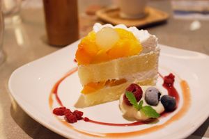 Vegan yellow cake with cream and fresh fruits.  at Mumokuteki Vegan Cafe in Kyoto