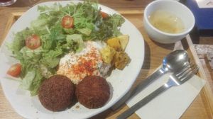 Bowl with rice, salad, tofu hamburger, soy mayonnaise at Mumokuteki Vegan Cafe in Kyoto