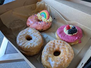 2 glazed brioche donuts, 1 strawberry sprinkle for gay pride, and 1 berry donut at Lovebirds Donuts in Kittery