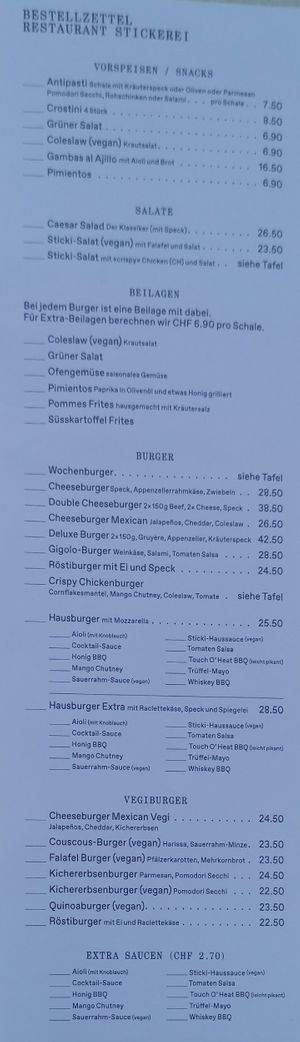 Menu with 4 different vegan Burges, fries, sweet potato fries vegan coleslaw at Stickerei in St Gallen