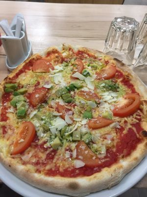 Vegan pizza with avocado and tomato at Classic & Vegan in Helsinki