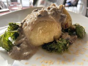 Mushroom stuffed potato patties with kale and shitake gravy.  at B12 in Girona