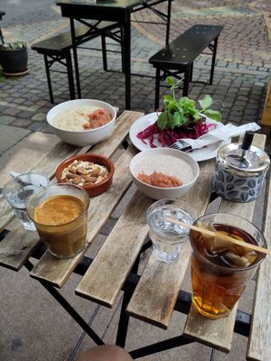 Open aubergine sandwich on top right, porridge lacking granola top left, chia dish lacking granola in the moddle at Cafe Sonja in Copenhagen