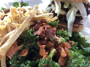 Transformed Salad with Royale with (cashew) cheese burger in the background at Pure Kitchen - Kanata in Ottawa
