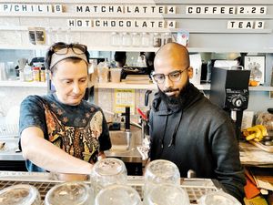 Tanya and Bear showing off Barista skills. at Animal Liberation Kitchen in Toronto