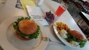 Classic burger (left) and Burger menu (right) plus optional Cole slaw (middle) and homemade lemonade (top). at Eaternia in Prague