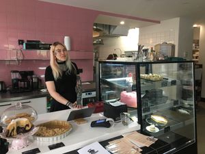 A member of the friendly staff with cool tattoos at Eaternia in Prague