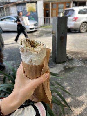 Medium falafel wrap (12 GEL, or about 4) and complimentary tap water in the back. :) at Muhudo Falafel Shop in Tbilisi