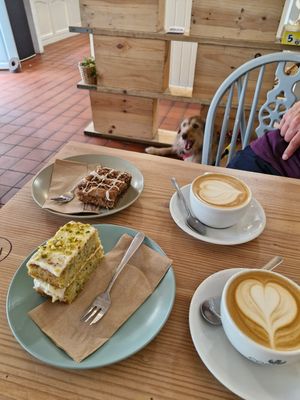 Cinnamon cake, pistachio and lime cake + flat white with oat at The Courtyard in Looe