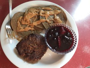 Housemade Beyond breakfast sausage patty, banana oat cakes with peanut butter and house made mixed berry syrup.  at The Red Bird Cafe in Roslyn