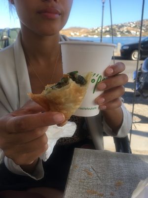 Enjoying a vegan coffee and vegan spinach pie  at Gregory's  in Paros