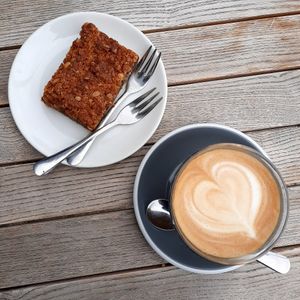 An oat milk latte and a date and orange slice at Nelson Coffee Co in Eastbourne