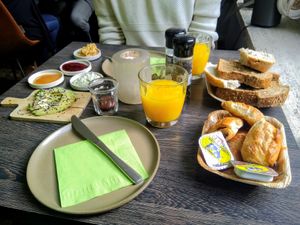 Charlie's breakfast veganized on demand: sliced bread, hummus, creamy tofu spread with fresh herbs, pear-vanilla jam, raspberry jam, homemade chocolate spread, freshly pressed oran at Charlie's in Antwerpen