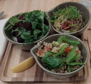 (Top-left) Beetroot-soy "koftas". (Top-right) Braised leek and finnish apple. (Bottom) quinoa-kisir salad, lemon and tahini sauce. at Hügge in Turku