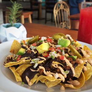 Everything Nachos! 💚 Belizean style nachos with our very own cashew cheese dip and veggie “meat”. These nachos are everything 🙌 at Origin  in San Pedro