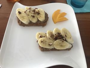 Banana bread topped with chocolate hummus, toasted pecans and banana slices at Origin  in San Pedro