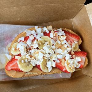 Peanut butter strawberry banana toast with toasted coconut and agave  at Sweet & Earthy in Raynham