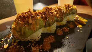 Spicy avocado sushi ($10). Terrible. Avocado paste on top of blocks of white rice. We didn't finish this. at REDWHITE BONELESS RAMEN - Boston in Boston