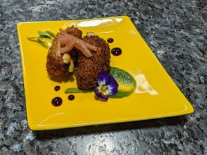 Two types of jalapeno cheese poppers coated in a coconut crust balanced with jicama and cucumber sauces at The Culinary Alchemists in Nuevo Arenal