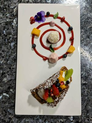 Dessert 1: taco filled with cream and fruit. Raspberry sauce spiral with fruit, basil, meringue and a vegan coconut raffaello! at The Culinary Alchemists in Nuevo Arenal