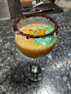 Passionfruit cocktail with a dried berry rim at The Culinary Alchemists in Nuevo Arenal