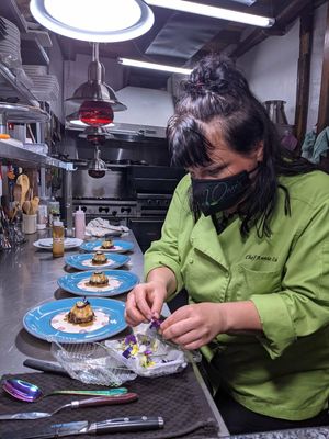Annie Lulu carefully plating the second dessert. at The Culinary Alchemists in Nuevo Arenal