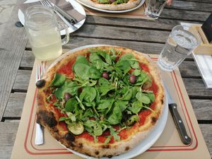 Vegan pizza with spinach, black beans, black olives and vegetables.  at Grad Kodeljevo  in Ljubljana