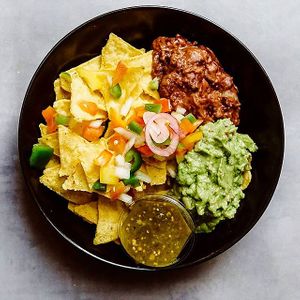 Nachos with guacamole, refried beans and salsa. at Tacopop in Copenhagen