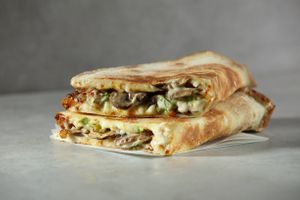 Vegan Philly Mushroom: Our new Italian flat-bread style papadia made from fresh dough with mushrooms, onion, green peppers, vegan cheese and ranch sauce at Papa John's in Sevenoaks