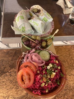 First part of the tapas board. On it are wraps with falafel, olives and a beetroot bulgur salad. at Bistro Calypso in Eindhoven