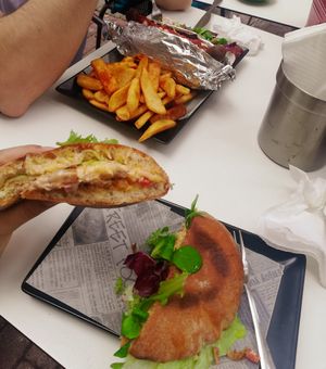 Vegan chicken ciabatta and vegan doggie with fries in the background at Choco Kebab Cafe in Bugibba