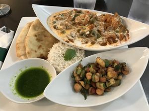 Vegetable Jalfrezi (vegan version), with Naan, Chickpea Salad, Basmati Rice and Cilantro Sauce.  Cilantro Indian Cafe at Cilantro Indian Cafe in Cary