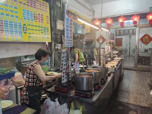 Kitchen and food prep, further in is the seating area at Shèng Lín SùShí in Kaohsiung