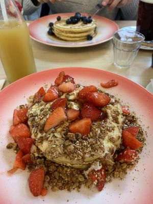 Vegan blueberry pancakes and vegan pancakes with plantbased yoghurt, granola and strawberries at Moak Pancakes - City Center in Amsterdam