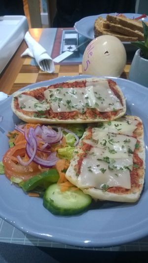 Vegan cheese and tomato pizza slices with salad  at Sea Change  in South Shields