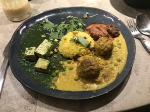 Palak tofu, butter curry with mushrooms and seitan, peas and raisins rice at Gives a Fork in Geneva