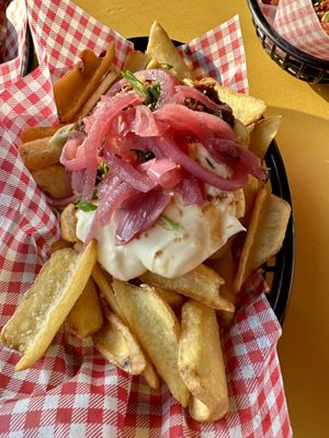 Loaded fries with mayonnaise and peanut sauce  at Pele Surf Shack in Hook Of Holland