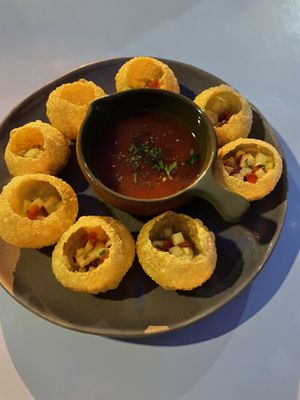 Gazpacho in little edible cups, pour it in and eat quickly  at O Gambuzino in Lisbon