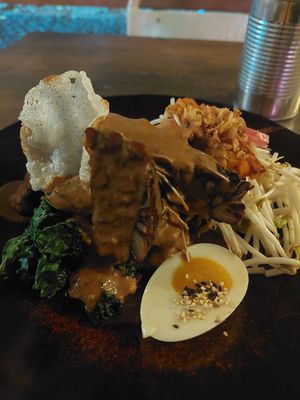 with satay sauce poured on at O Gambuzino in Lisbon