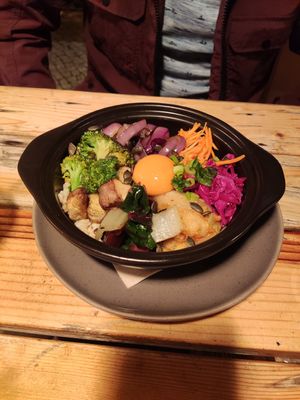 Salad bowl with vegan egg yolk at O Gambuzino in Lisbon