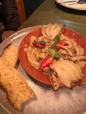 Traditional Portuguese p*rk dish at O Gambuzino in Lisbon