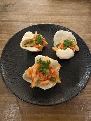 Rice crackers with homemade kimchi  at O Gambuzino in Lisbon