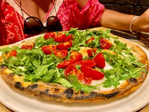 Gluten-free pizza with vegan cheese, fresh pendolini or cherrry tomatoes and rocket. at Pizzeria del Ponte in Recco