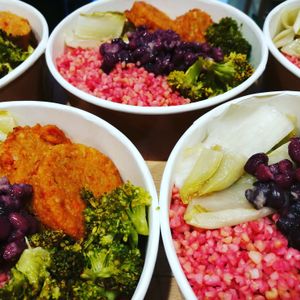 Buddha bowls with beetroot bulgur, mixed vegetables and vegan burger at Nectare in Bologna