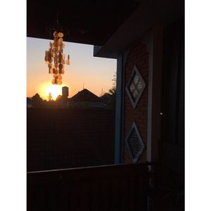 Upstairs seating area and the kitchen- view over central Ubud with sunset at Urban Jungle in Ubud