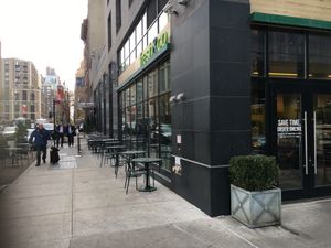 Entrance and outdoor seating.  at fresh&co - 10th Ave in New York City